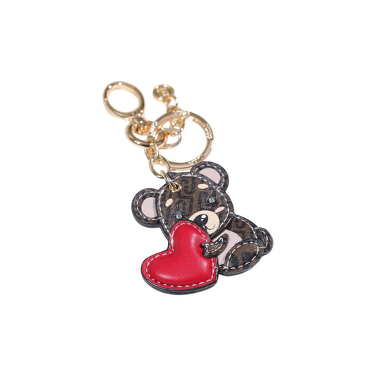 Portachiavi Liu Jo Orsetto; Marrone. 100% Poliuretano, dettagli dorati, moschettone e anello inclusi. Design con orsetto e cuore, ideale per personalizzare borse. Accessorio 4 stagioni. Vista frontale