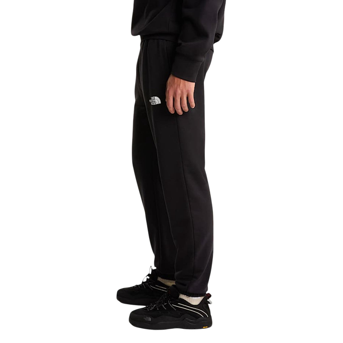 Joggers The North Face Simple Dome Light; 68% cotone, 32% poliestere, 295g. Vita con coulisse, interno spazzolato, orli elastici. Pantaloni sportivi leggeri, caldi e traspiranti. Vista laterale