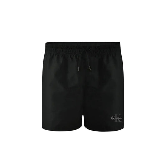 Calvin Klein Monogram Swim Shorts; neri, lunghezza corta, poliestere impermeabile, coulisse regolabile, logo iconico. Il costume essenziale per l'estate. Vista frontale stesa