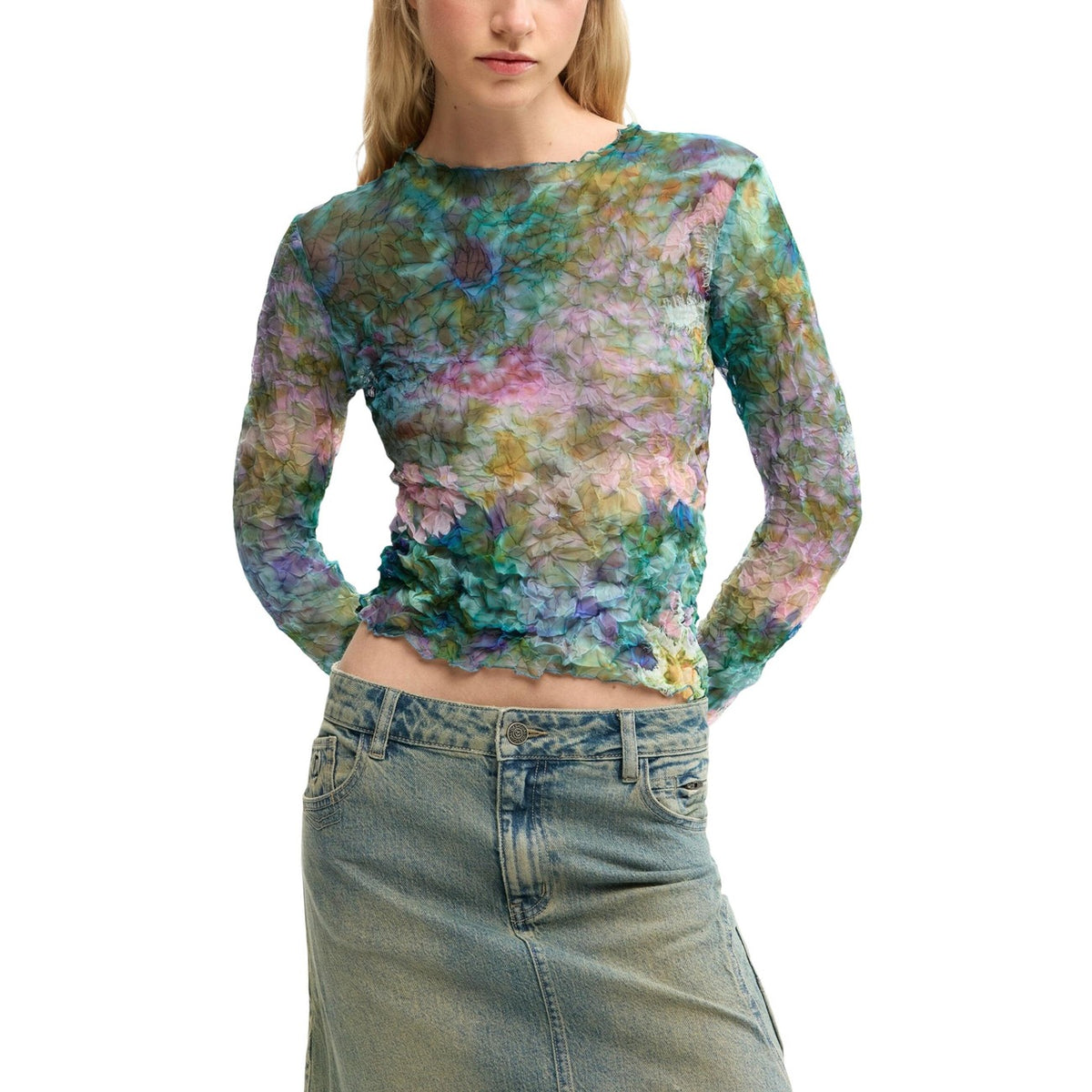 Blusa in tessuto testurizzato con stampa floreale digitale su tutto il capo. Presenta scollo rotondo e maniche lunghe con polsini aderenti. Taglio regular e design in colore blu minerale. Vista frontale indossata da modella