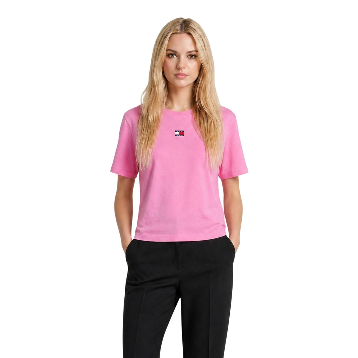 T-shirt Tommy Jeans donna fucsia modello DW0DW22202. Maglietta a maniche corte girocollo in cotone sostenibile fucsia acceso a vestibilità comoda, con patch logo classica Tommy Jeans sul davanti, stile casual e sportivo.