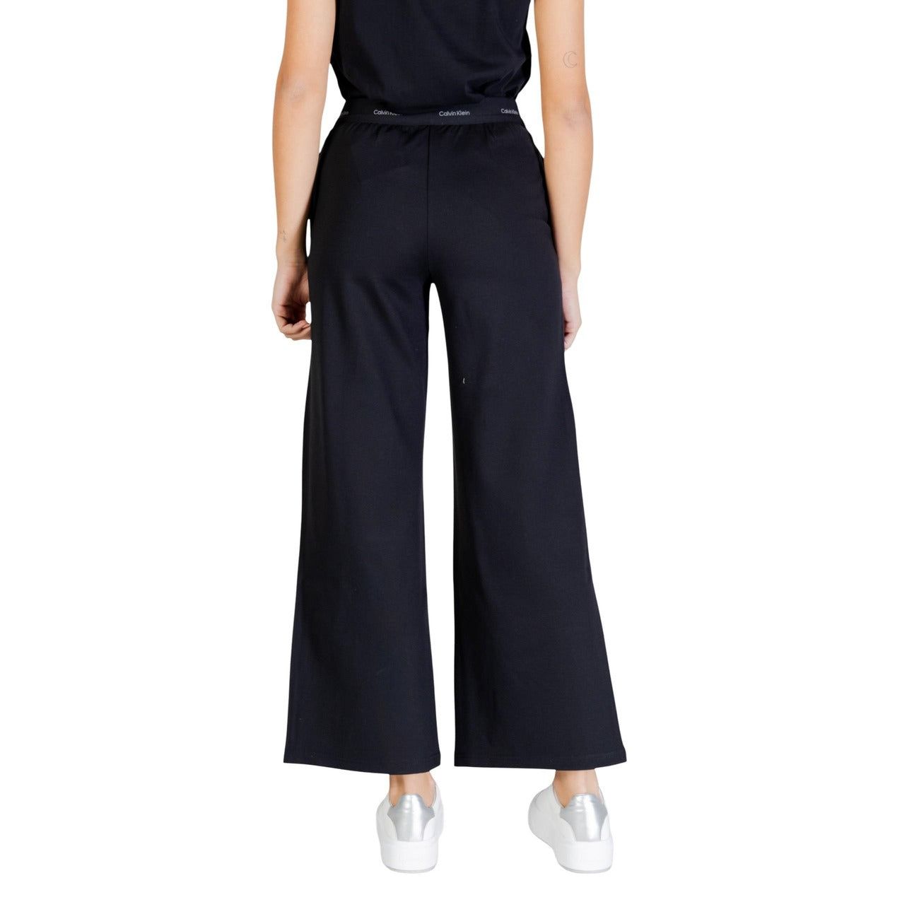 Calvin Klein Jeans Donna LV044E622G; pantaloni ampi neri, vita elasticizzata logata, tessuto comfort stretch. Eleganza sportiva quotidiana. Vista posteriore 