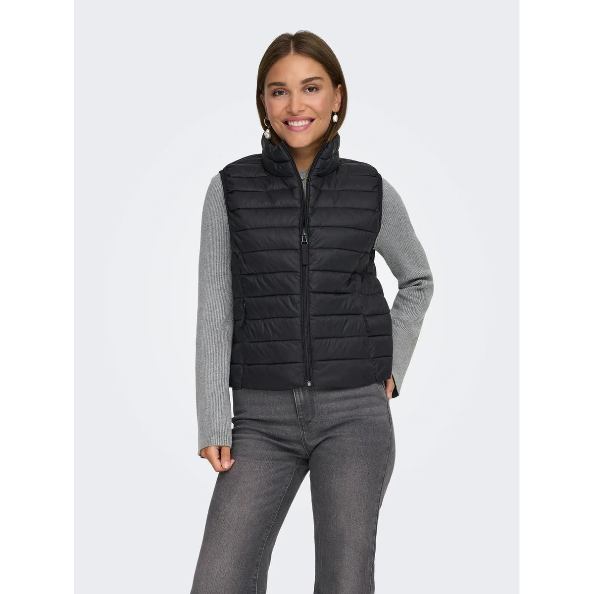 Gilet smanicato da donna Only codice 15351970 in nylon nero resistente all'acqua con collo alto, chiusura a zip e tasche con cerniera.