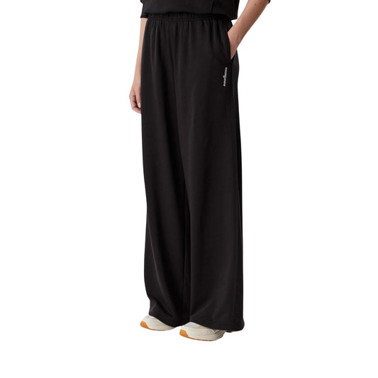Pantaloni Tuta Donna Neri Tommy Hilfiger Jeans; Pantalone a gamba ampia wide leg in cotone e poliestere riciclato. Vita elastica regolabile, tasche laterali e logo ricamato. Stile casual e sportivo. Frontale laterale 
