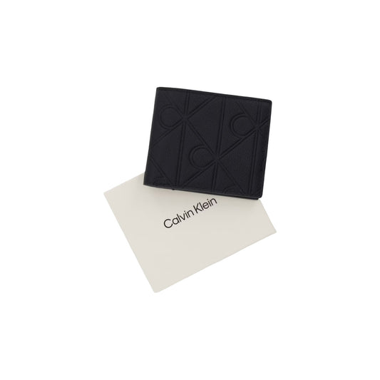 Portafoglio Compatto Uomo Calvin Klein; Nero. 100% Cuoio martellato con loghi incisi a rilievo, chiusura con zip, scomparti interni per tessere (senza portamonete). Dimensioni micro (7x9 cm), stile minimalista 4 stagioni. Vista con confezione 