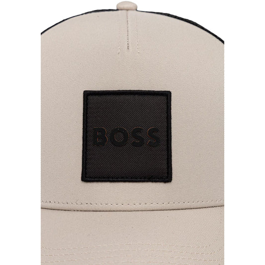 Cappellino Boss uomo beige e nero modello ELLIOT-PL. Berretto stile trucker in poliestere con visiera curva, pannello frontale beige con patch logo Boss quadrato nero e sezione posteriore in rete traspirante, cappello streetwear casual regolabile.