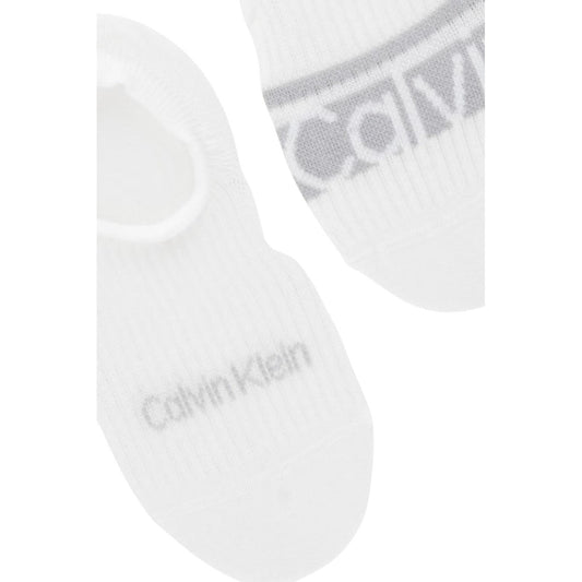 Pack 2 Paia Fantasmini CK Jeans; Bianco. 65% Cotone, 32% Poliammide, 3% Elastam. Modello High Cut con doppio logo, elastico rinforzato, traspiranti e resistenti Dettaglio logo 