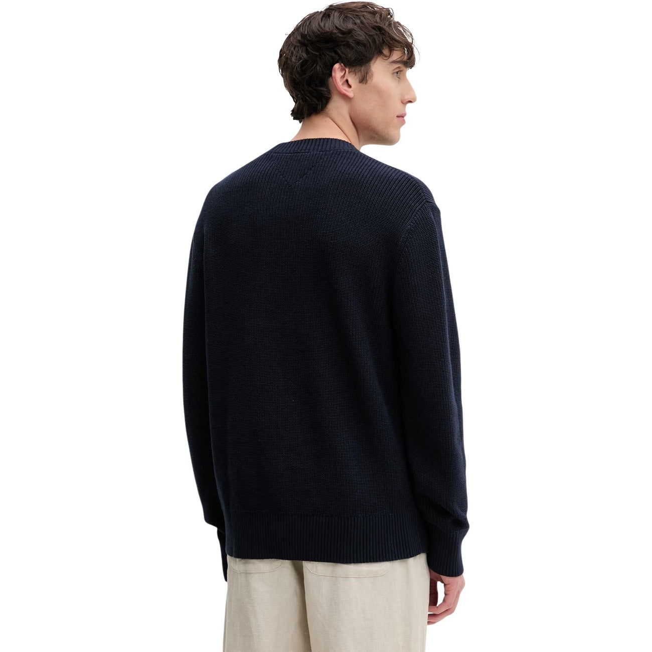 Maglione Tommy Jeans uomo blu DM0DM20923. Pullover a girocollo in cotone sostenibile con lavorazione a maglia spessa, maniche lunghe, bordi a costine e logo classico applicato sul petto.