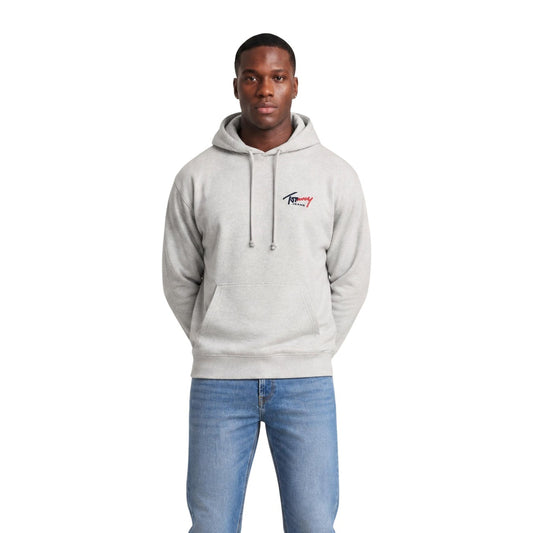 Felpa Grigia con Cappuccio Tommy Jeans; 100% Cotone Rigenerato. Tasca a marsupio, logo ricamato, finiture a costine. Stile casual, materiale ecosostenibile, ideale per l'uso quotidiano. Frontale 