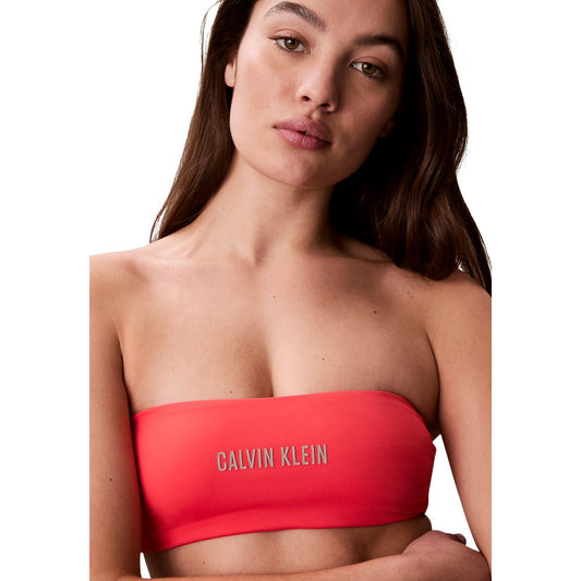 Top Bikini Fascia CK Intense Power; Arancione. Design trasformabile (con/senza spalline), tessuto Lycra XTRA LIFE®, logo stampato. Coppe preformate, asciugatura rapida, stile moderno e resistente.