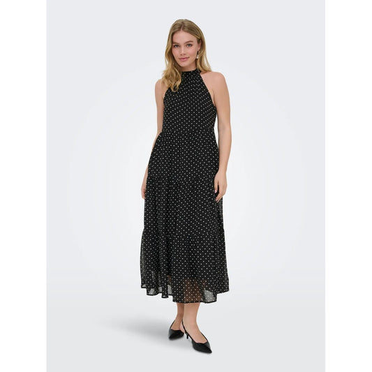 Abito Lungo Donna Nero a Pois Only; Vestito smanicato oversize con scollo all'americana, chiusura con zip e dettaglio fiocco. Tessuto leggero e fluido quattro stagioni, stile casual-elegante per eventi. Vista frontale 