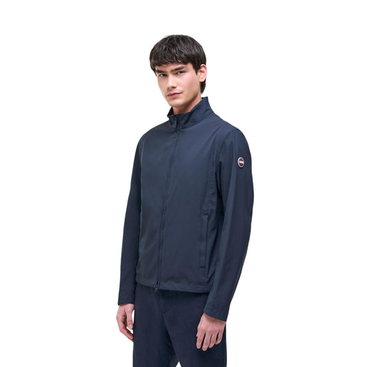 Giacca Colmar Originals blu navy uomo 1816N 6WV. Giambotto leggero antipioggia da uomo blu scuro in softshell stretch idrorepellente e antivento, giacca senza imbottitura mezza stagione con zip doppio cursore e coulisse, stile casual sportivo.