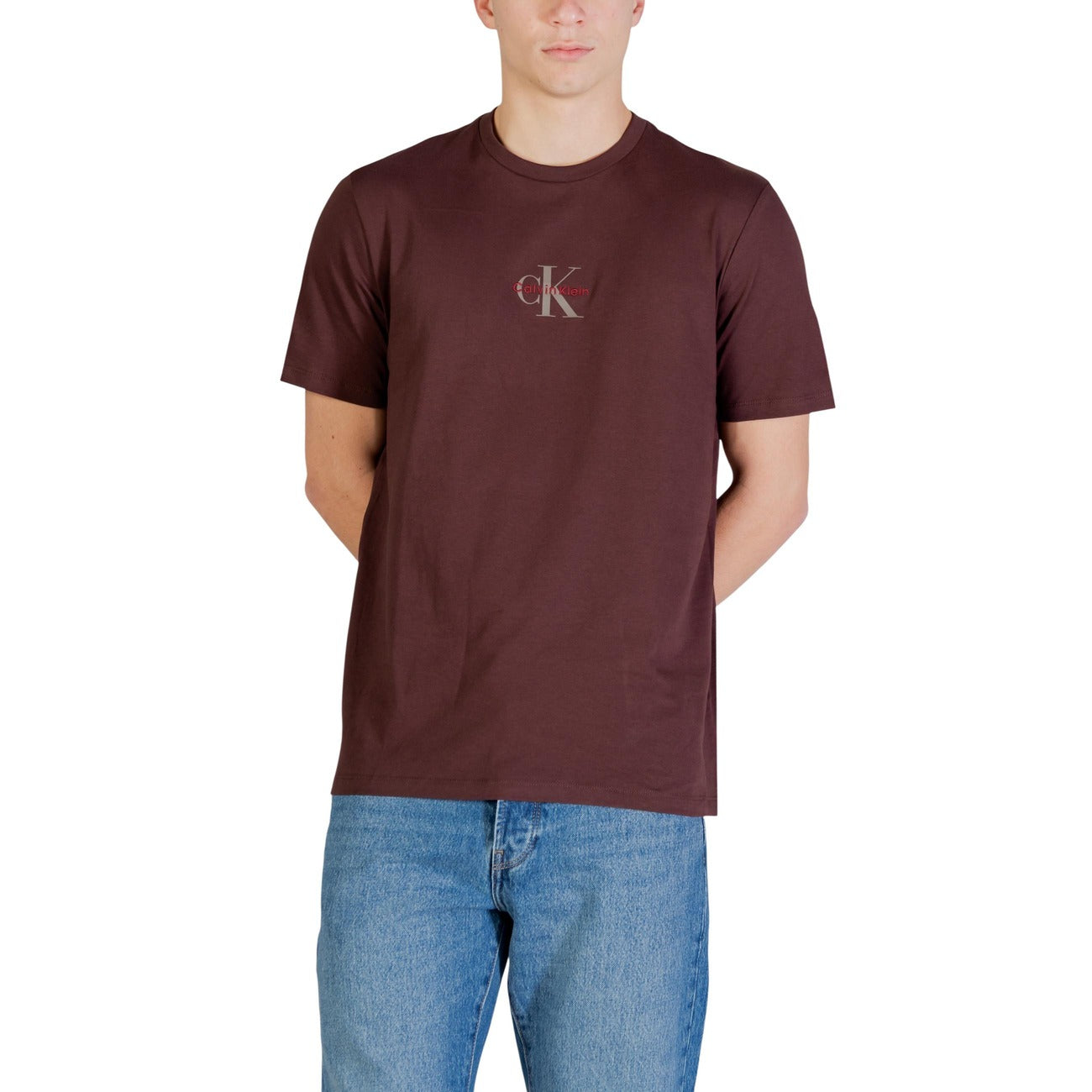 T-shirt CK Jeans Marrone; 100% Cotone. Regular fit, logo piccolo sul petto, scollatura a girocollo. Comfort naturale e stile versatile. Vista frontale 