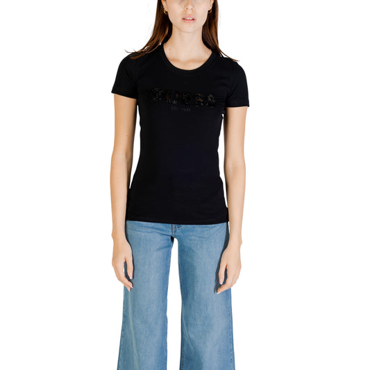 T-shirt Slim Girocollo Donna Guess Logo Paillettes; Tessuto 95% cotone biologico e 5% lycra a maniche corte. Scritta Guess frontale con paillettes luminose ricamate, stile casual-luxury ecosostenibile. Nero vista frontale 