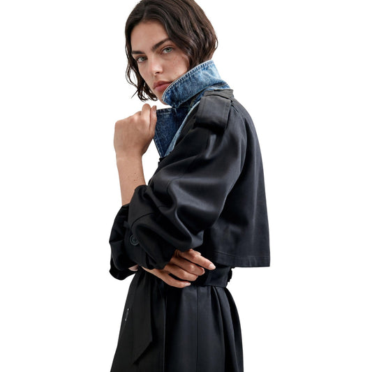 Trench Desigual donna nero CHAQ HYBRIDTRENCH. Soprabito lungo doppiopetto con bottoni, cintura in vita e collo a contrasto, abbigliamento donna autunno inverno in cotone BCI e lyocell Lenzing.
