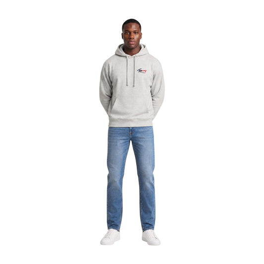 Felpa Grigia con Cappuccio Tommy Jeans; 100% Cotone Rigenerato. Tasca a marsupio, logo ricamato, finiture a costine. Stile casual, materiale ecosostenibile, ideale per l'uso quotidiano. Figura intera frontale 