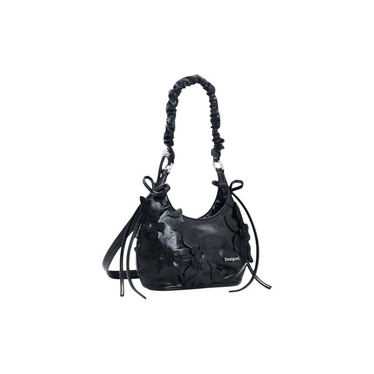 Borsa Desigual donna nera modello BAG_NEXUS BIRA. Borsa a mano piccola in ecopelle nera con fiori 3D applicati in rilievo, manico a braccio arricciato, fiocchi laterali e tracolla rimovibile, borsa elegante e casual stile bon ton per la collezione autunno inverno.