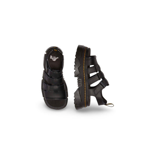 Dr. Martens Sandalo Mattison Platform; Nero. 100% Pelle Athena opaca. Tacco 5 cm, suola ibrida EVA/PVC, sottopiede in camoscio e chiusura a fibbia. Dettagli originali Dr. Martens con cuciture gialle.