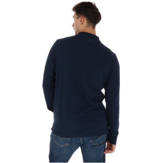 Polo uomo Timberland Millers River manica lunga blu TBC0YHBE. Maglia polo traspirante in cotone biologico sostenibile con collo a bottoni, vestibilità regolare e logo Timberland ricamato.