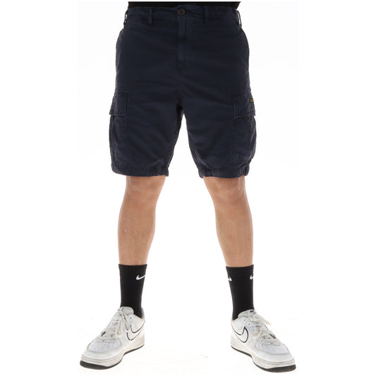 Bermuda Cargo Superdry Blu Navy; 100% Cotone Twill. Sei tasche funzionali, vestibilità dritta, patch logo. Tessuto resistente e traspirante. Ideale per il tempo libero e l'estate. Vista frontale 